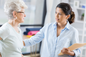 Physical Therapist talks with senior woman